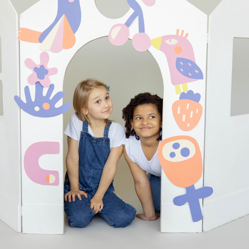 Two children in cardboard house